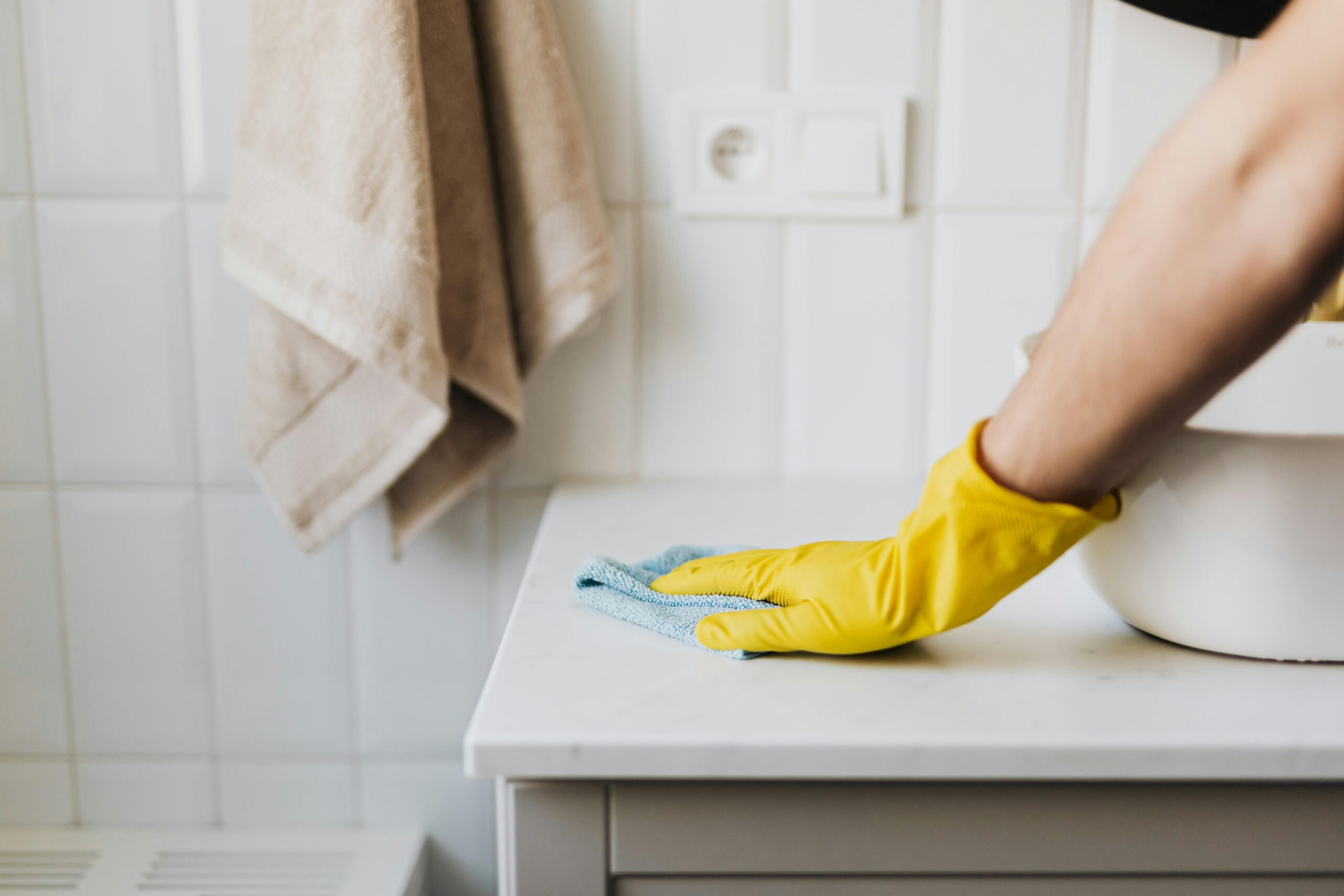 The White Glove Maid Service Cleaning with a blue rag